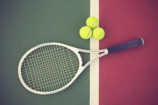 Tennis racquet and balls on a court